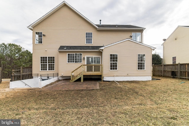 back of house featuring a patio area, a fenced backyard, and a lawn