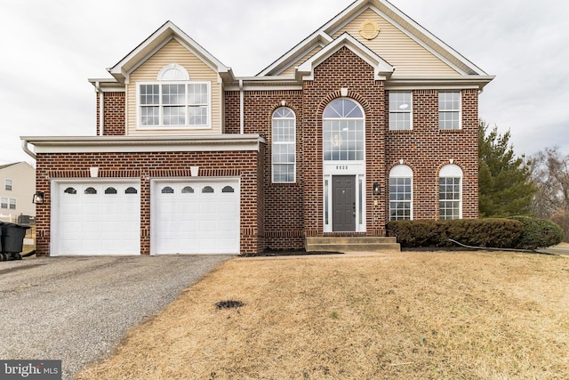 view of front of house with a garage, a front yard, brick siding, and driveway