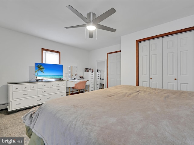 bedroom with a baseboard radiator, a closet, carpet flooring, and ceiling fan