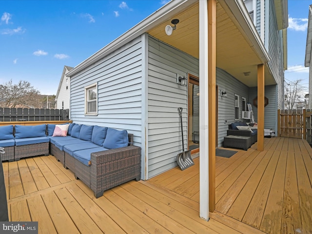 wooden terrace with fence and outdoor lounge area