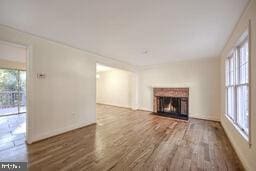 unfurnished living room with a fireplace and wood finished floors