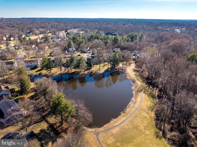 bird's eye view with a water view and a wooded view