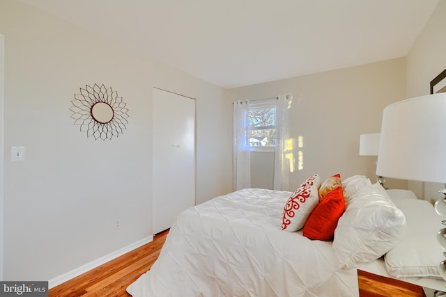 bedroom featuring light wood-style floors and baseboards