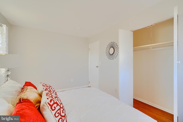 bedroom with baseboards and wood finished floors