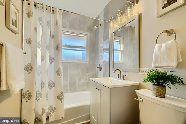 full bath with vanity, toilet, and shower / tub combo with curtain