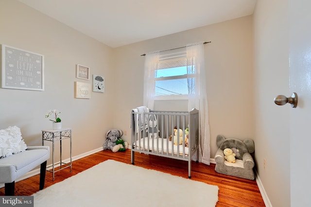 bedroom featuring wood finished floors and baseboards