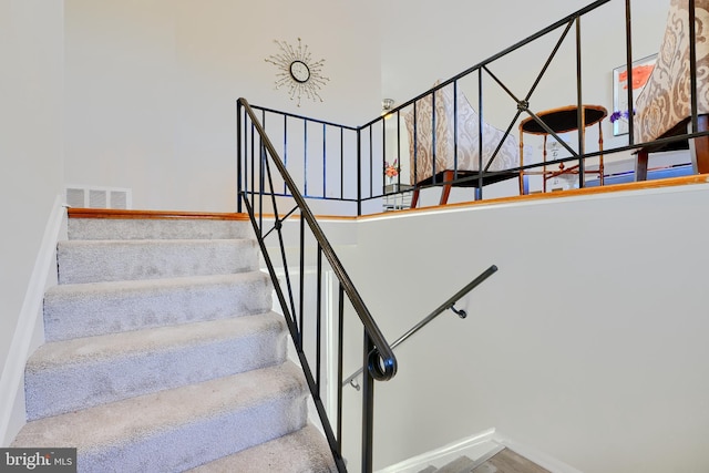 stairs featuring baseboards and visible vents