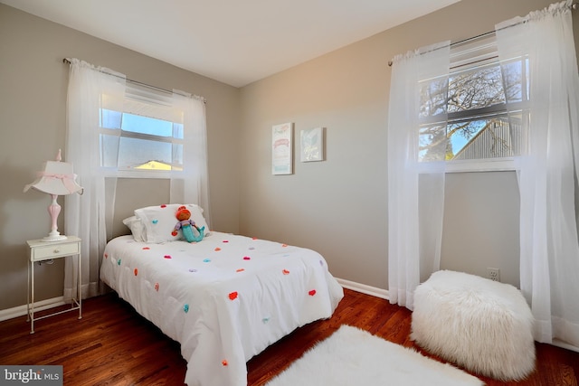 bedroom with wood finished floors and baseboards