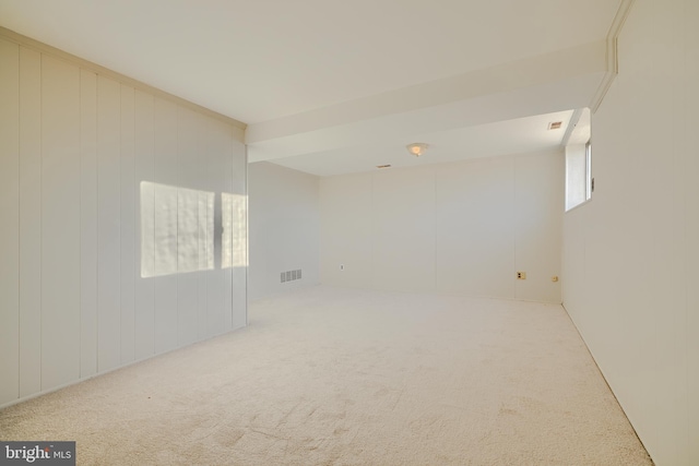 carpeted spare room featuring visible vents