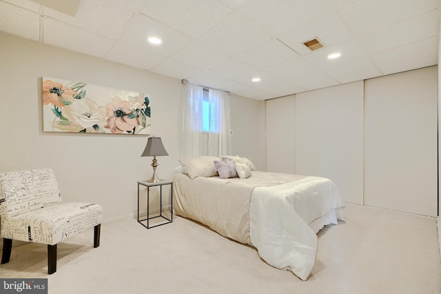 bedroom with a paneled ceiling, carpet, visible vents, and recessed lighting