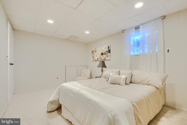 bedroom featuring a paneled ceiling, recessed lighting, baseboards, and light colored carpet