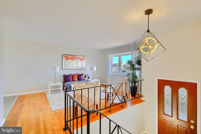 entryway with baseboards and wood finished floors