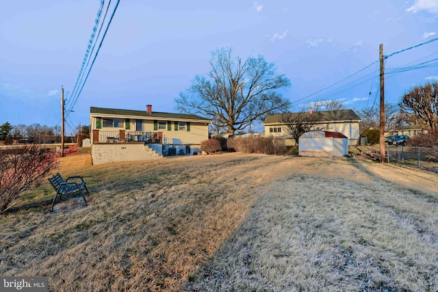 ranch-style house featuring an outbuilding and fence