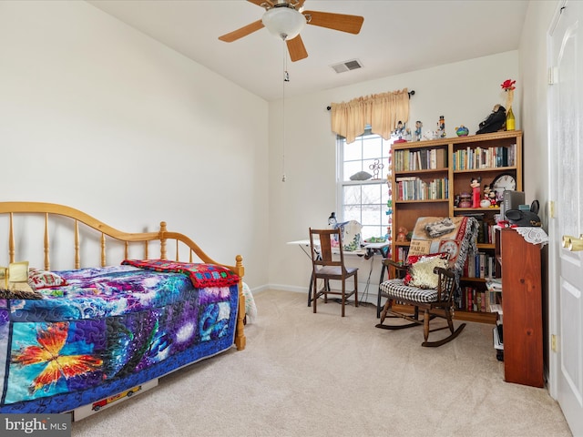 carpeted bedroom featuring baseboards, visible vents, and a ceiling fan