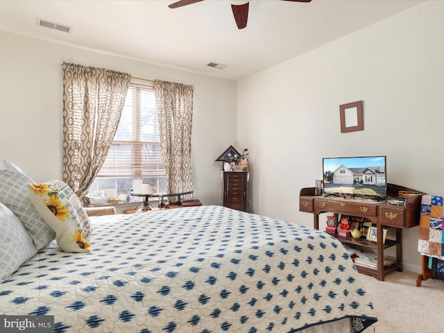 carpeted bedroom featuring ceiling fan and visible vents