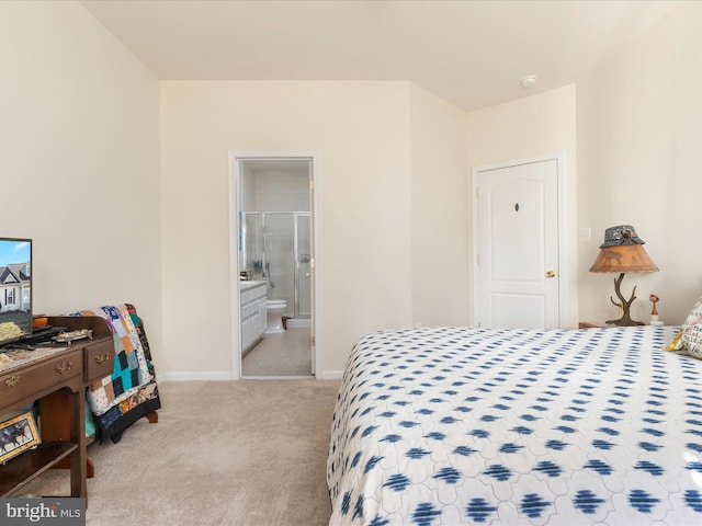 carpeted bedroom with baseboards and ensuite bathroom