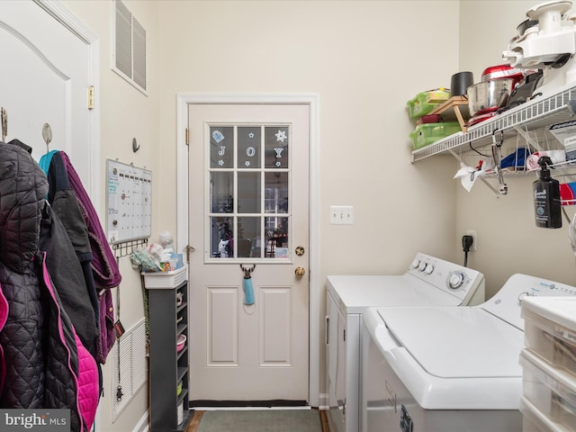 laundry room with laundry area, visible vents, and washing machine and clothes dryer