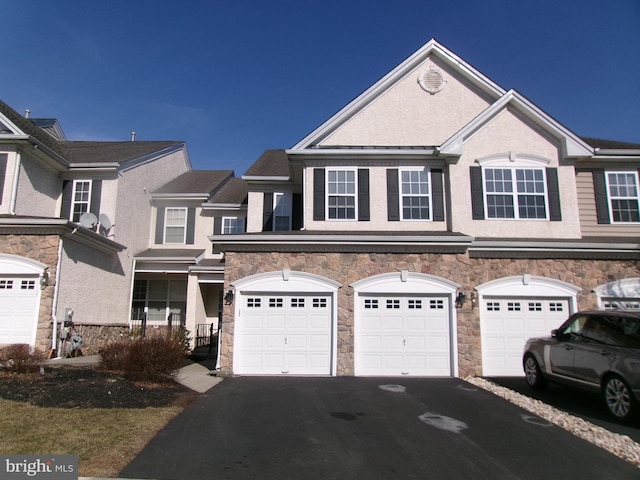 view of property featuring a garage and driveway