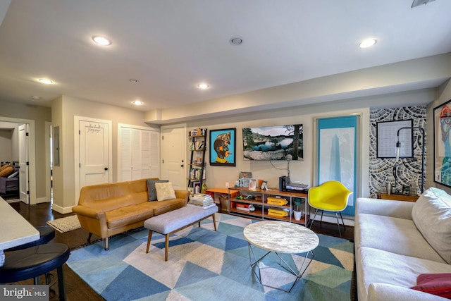 living area featuring recessed lighting, baseboards, and wood finished floors