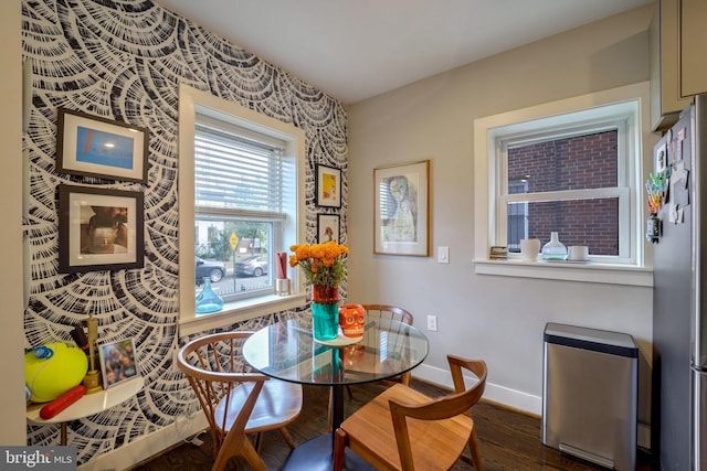 dining area featuring baseboards and dark wood-style flooring