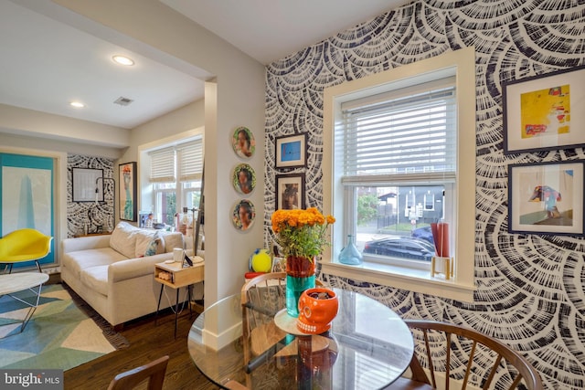 dining room with baseboards, dark wood-type flooring, plenty of natural light, and wallpapered walls