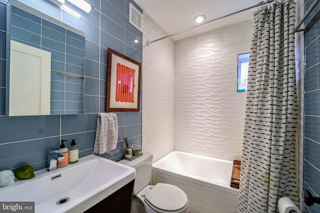 bathroom featuring tile walls, shower / bathtub combination, decorative backsplash, toilet, and vanity