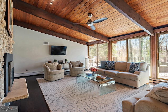 living room featuring visible vents, baseboard heating, a fireplace, wood finished floors, and a baseboard radiator