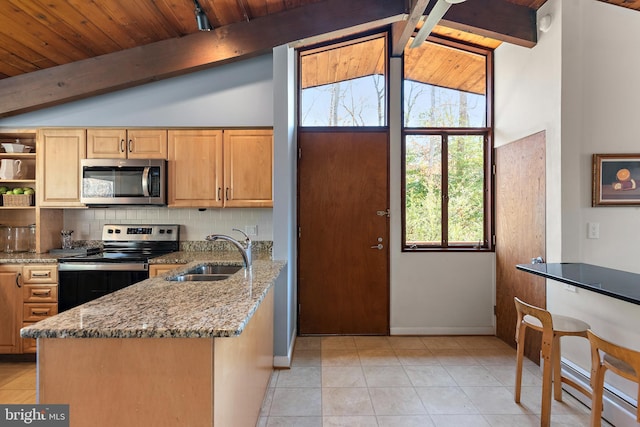 kitchen with light stone counters, vaulted ceiling with beams, a sink, appliances with stainless steel finishes, and tasteful backsplash