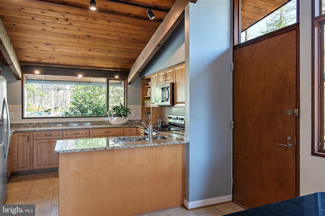 kitchen featuring a sink, stone countertops, backsplash, appliances with stainless steel finishes, and light tile patterned flooring