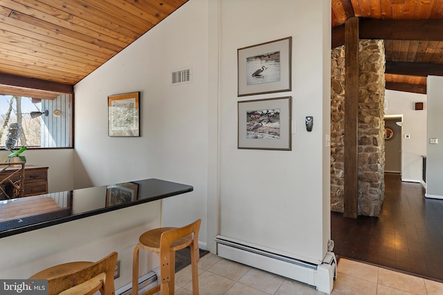 tiled dining space featuring a baseboard radiator, visible vents, wooden ceiling, and vaulted ceiling with beams