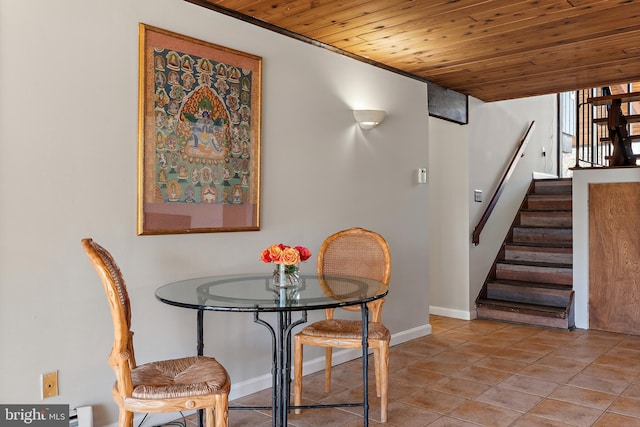 tiled dining space featuring stairs, wood ceiling, baseboards, and baseboard heating