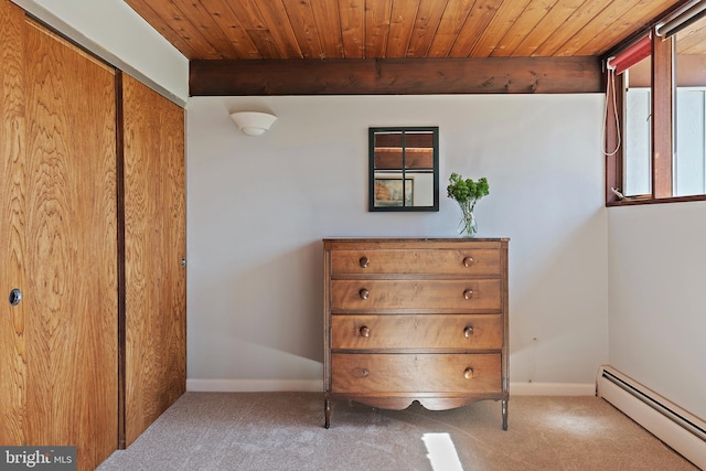 unfurnished bedroom featuring beamed ceiling, carpet, baseboards, baseboard heating, and wood ceiling