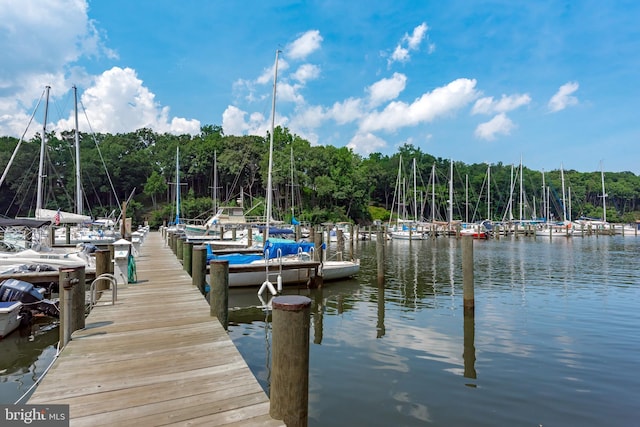 dock area featuring a forest view and a water view