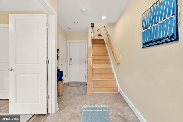 staircase with tile patterned flooring and baseboards