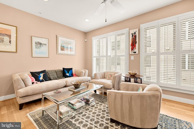 living area featuring a ceiling fan, recessed lighting, baseboards, and wood finished floors