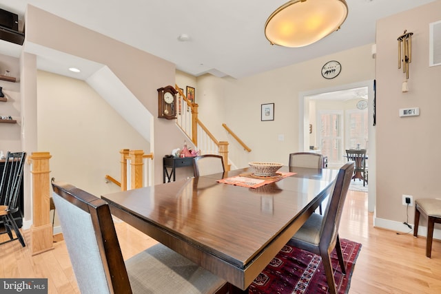 dining room with baseboards and light wood-style floors