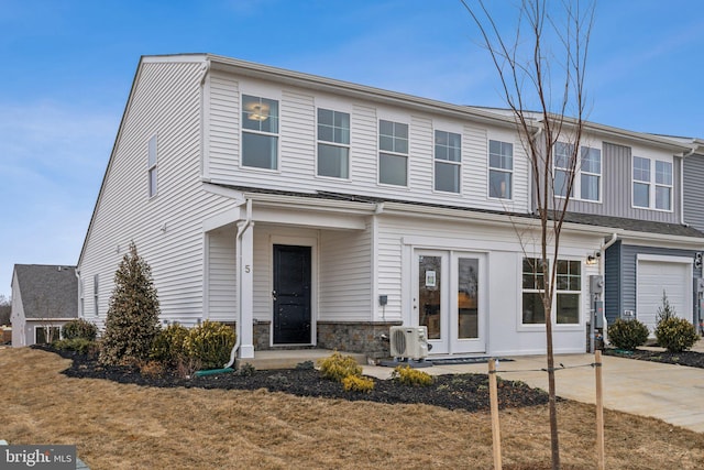 view of front of property featuring ac unit and stone siding