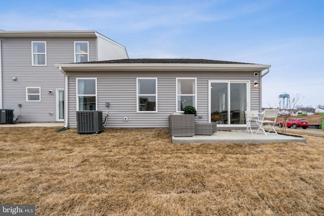 back of property featuring a patio area, central AC unit, and a yard