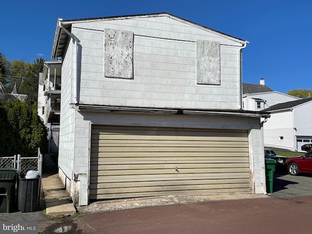 exterior space with a garage and fence