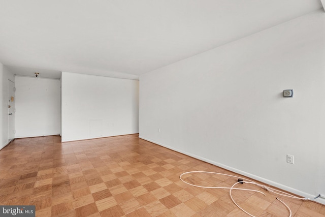 unfurnished room featuring baseboards