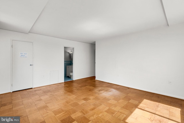 unfurnished room with baseboards