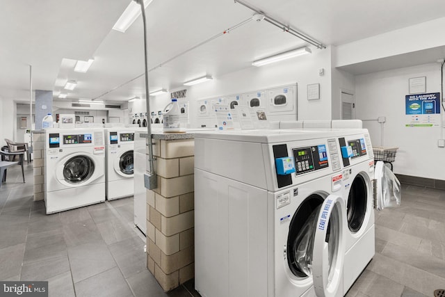 shared laundry area with light tile patterned floors, washer and clothes dryer, and stacked washer / drying machine