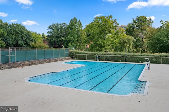 pool featuring a patio area and fence