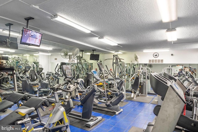 gym with a textured ceiling and visible vents