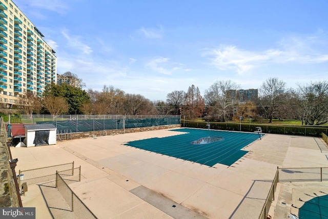 view of pool featuring a patio and fence