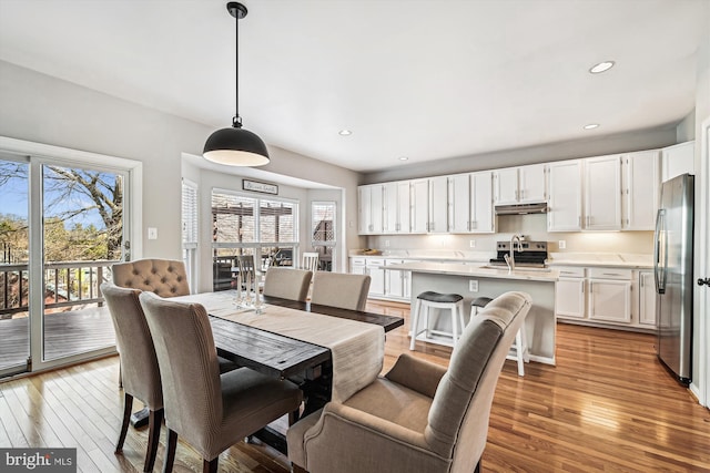 dining area with recessed lighting and light wood finished floors