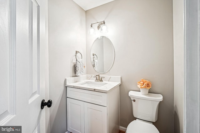 bathroom featuring toilet and vanity