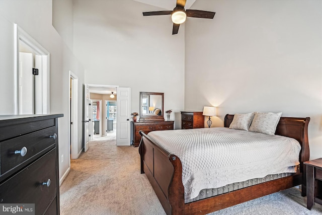 bedroom with light colored carpet, baseboards, a towering ceiling, and ceiling fan