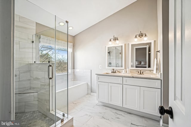 bathroom featuring a sink, a garden tub, marble finish floor, and a stall shower