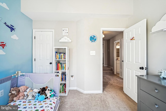 bedroom featuring baseboards and light carpet